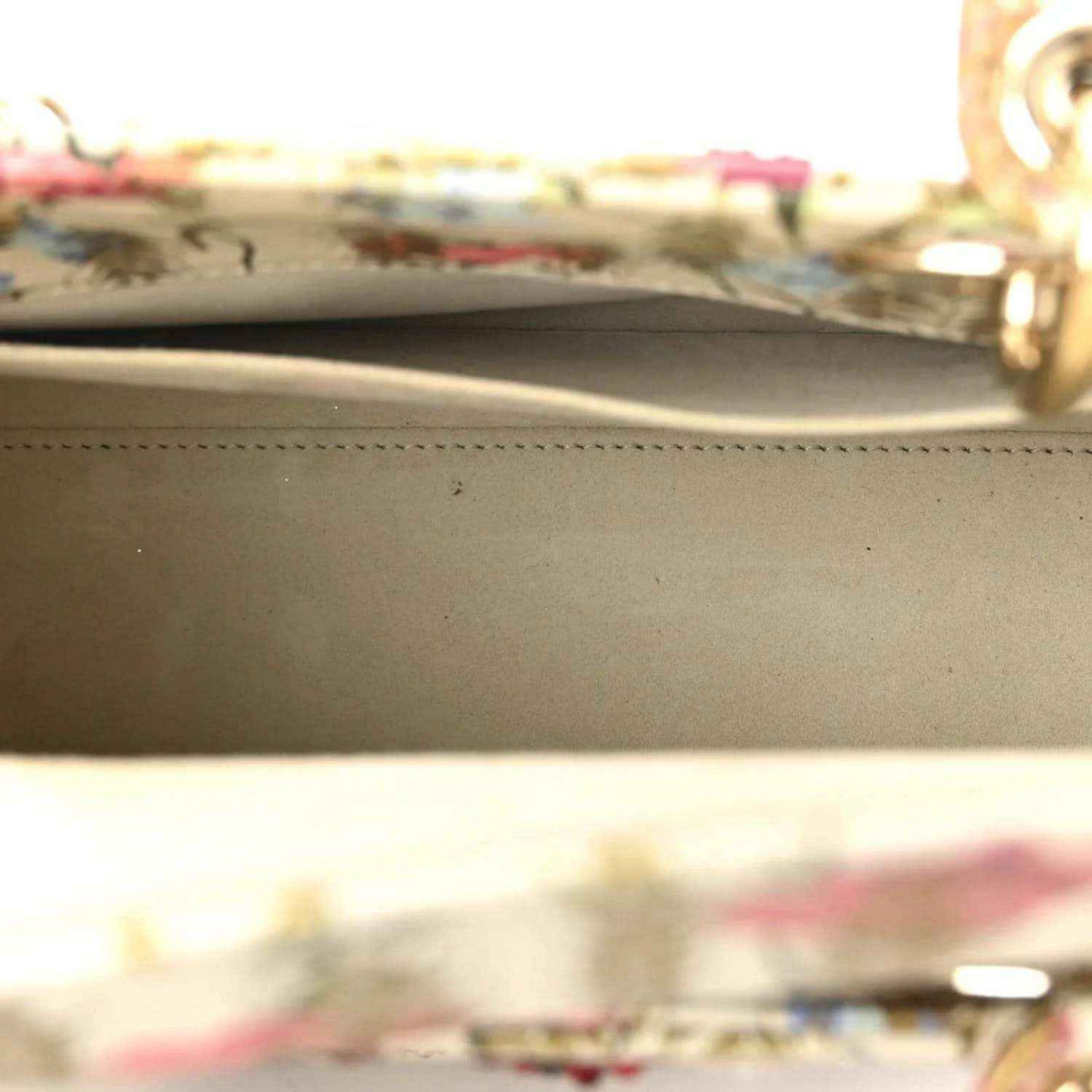 Tote bag interior with beige lining and gold-tone zipper stitching