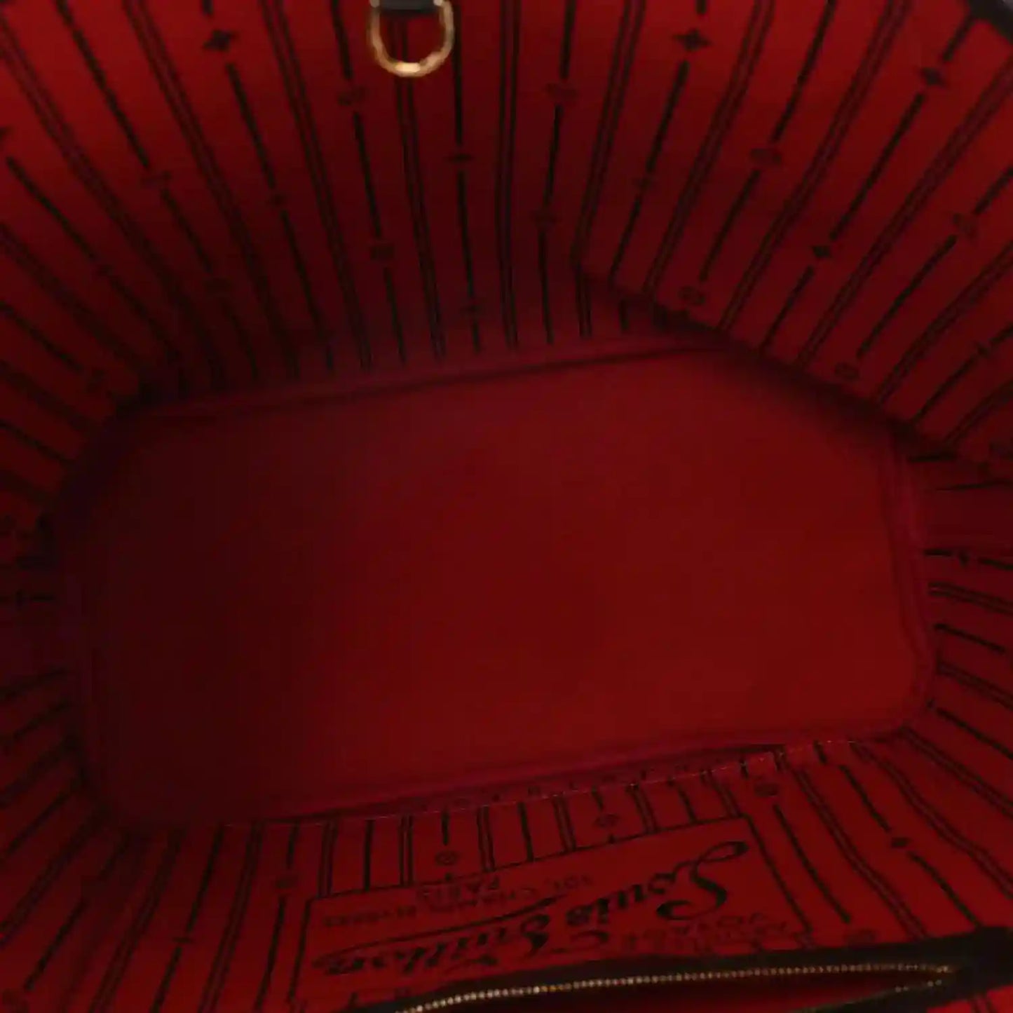 Red fabric-lined interior of Damier Ebene tote bag with zip opening and stitching
