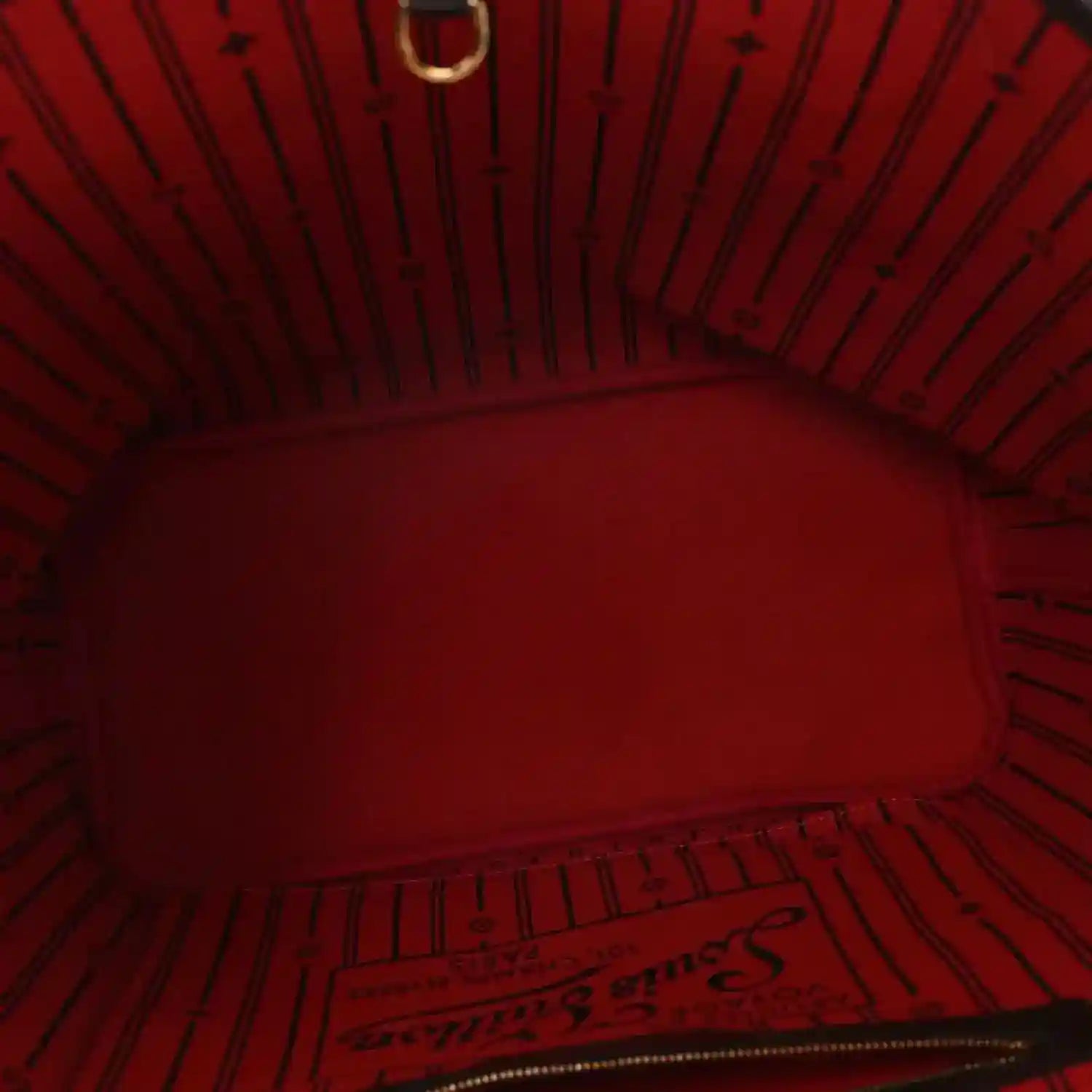 Red fabric-lined interior of Damier Ebene tote bag with zip opening and stitching