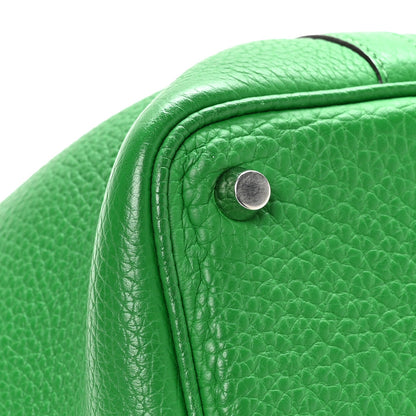Green leather tote bag corner with round snap stud hardware