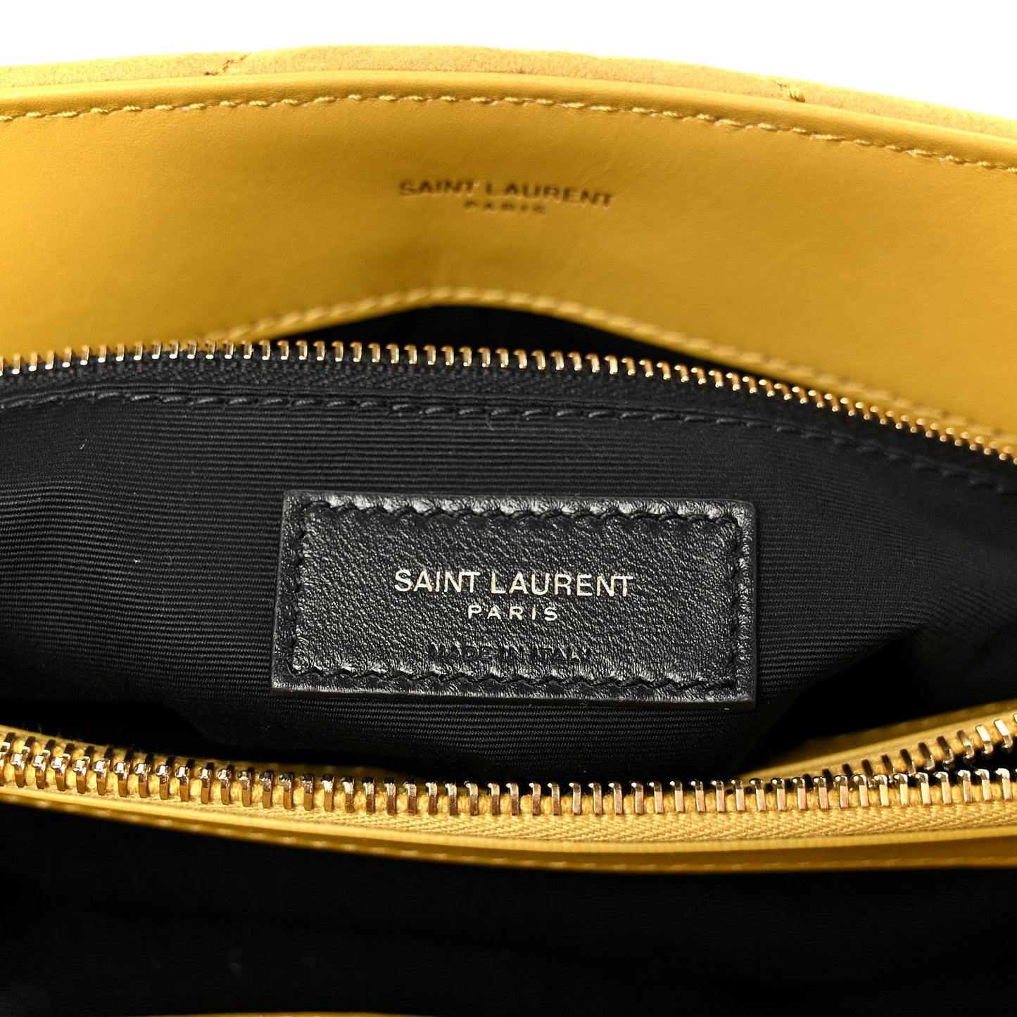 Black fabric interior label pocket with “SAINT LAURENT PARIS” under zipper