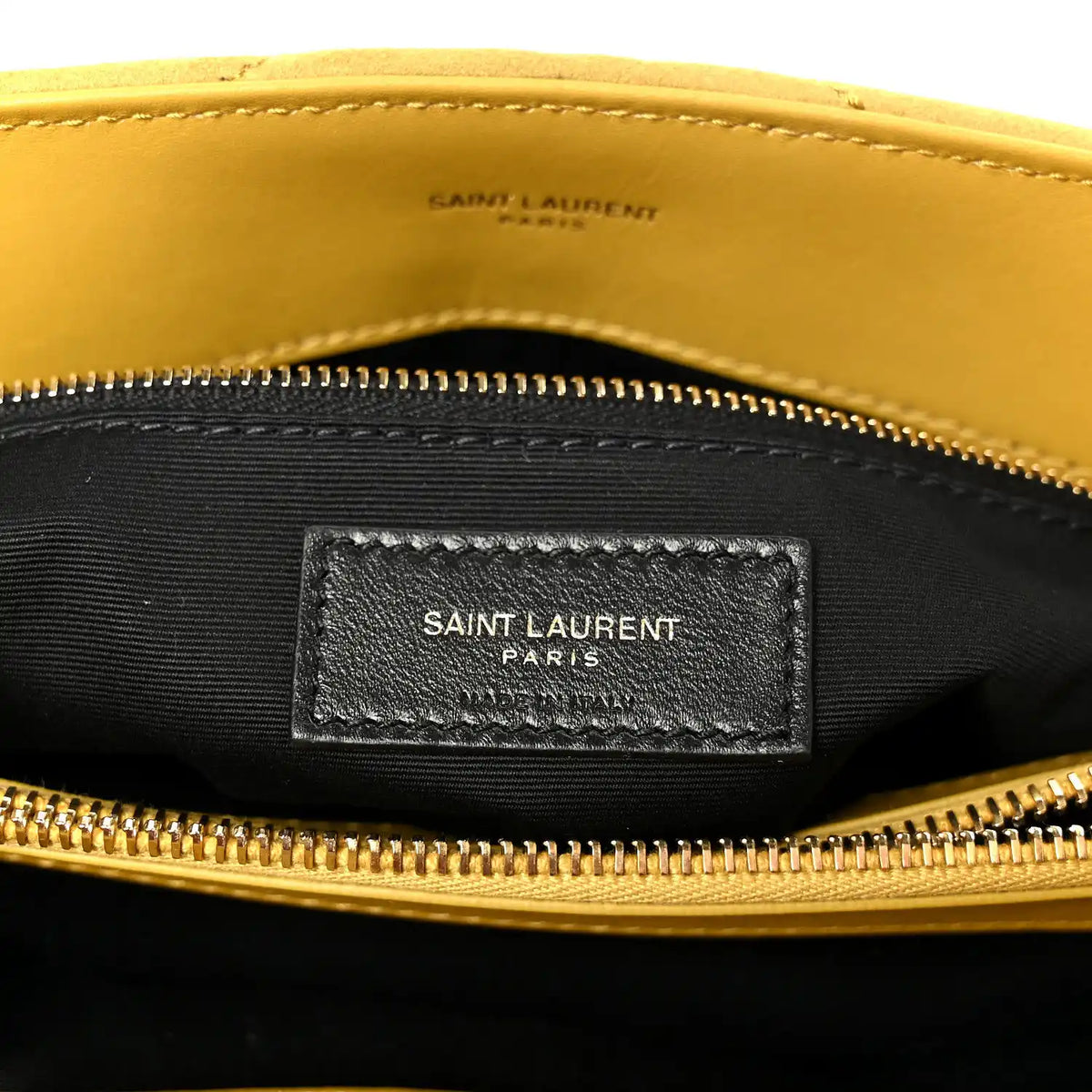 Black fabric interior label pocket with “SAINT LAURENT PARIS” under zipper
