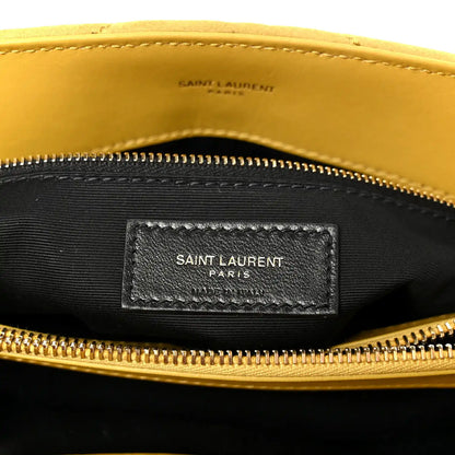 Black fabric interior label pocket with “SAINT LAURENT PARIS” under zipper