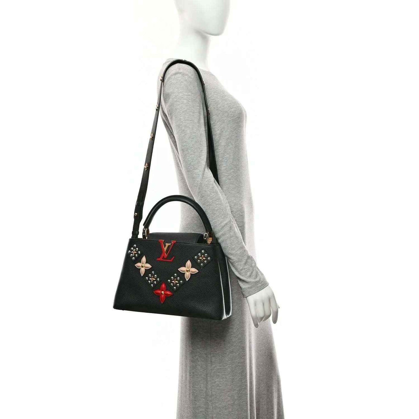 Black Louis Vuitton handbag with gold trim, short handles, and floral charm details