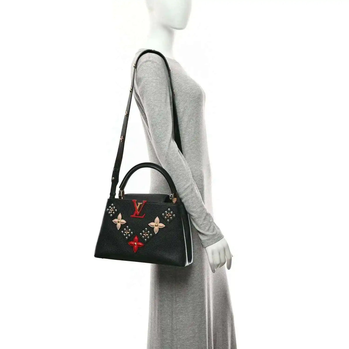 Black Louis Vuitton handbag with gold trim, short handles, and floral charm details