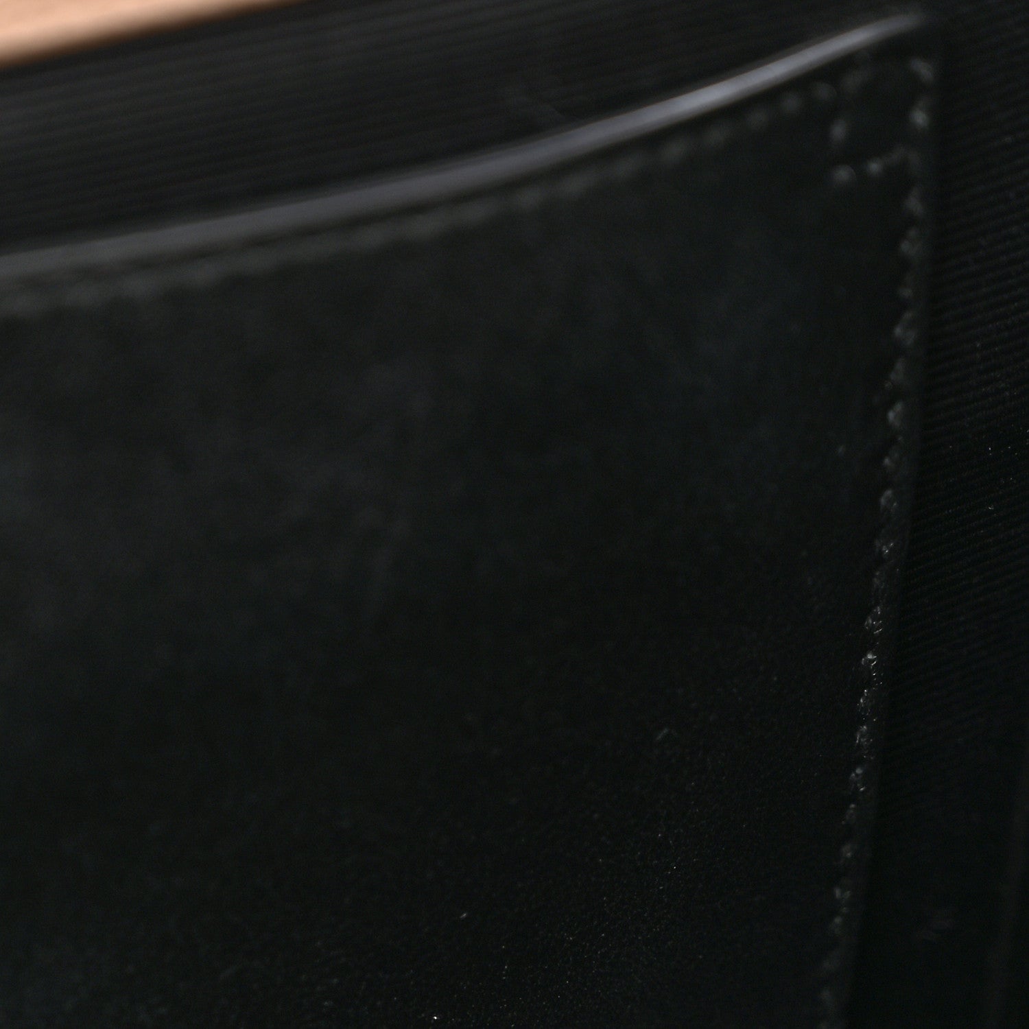 Black fabric lining interior panel with stitched edge