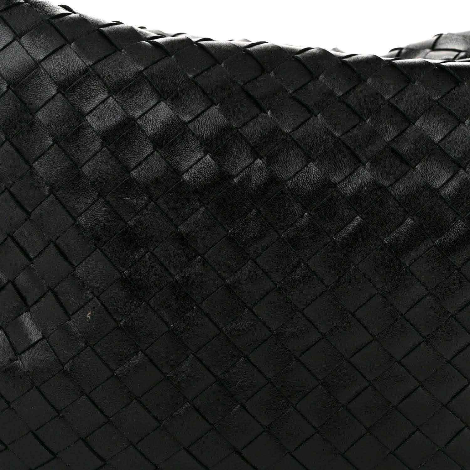 Black woven leather bag panel with intrecciato square pattern