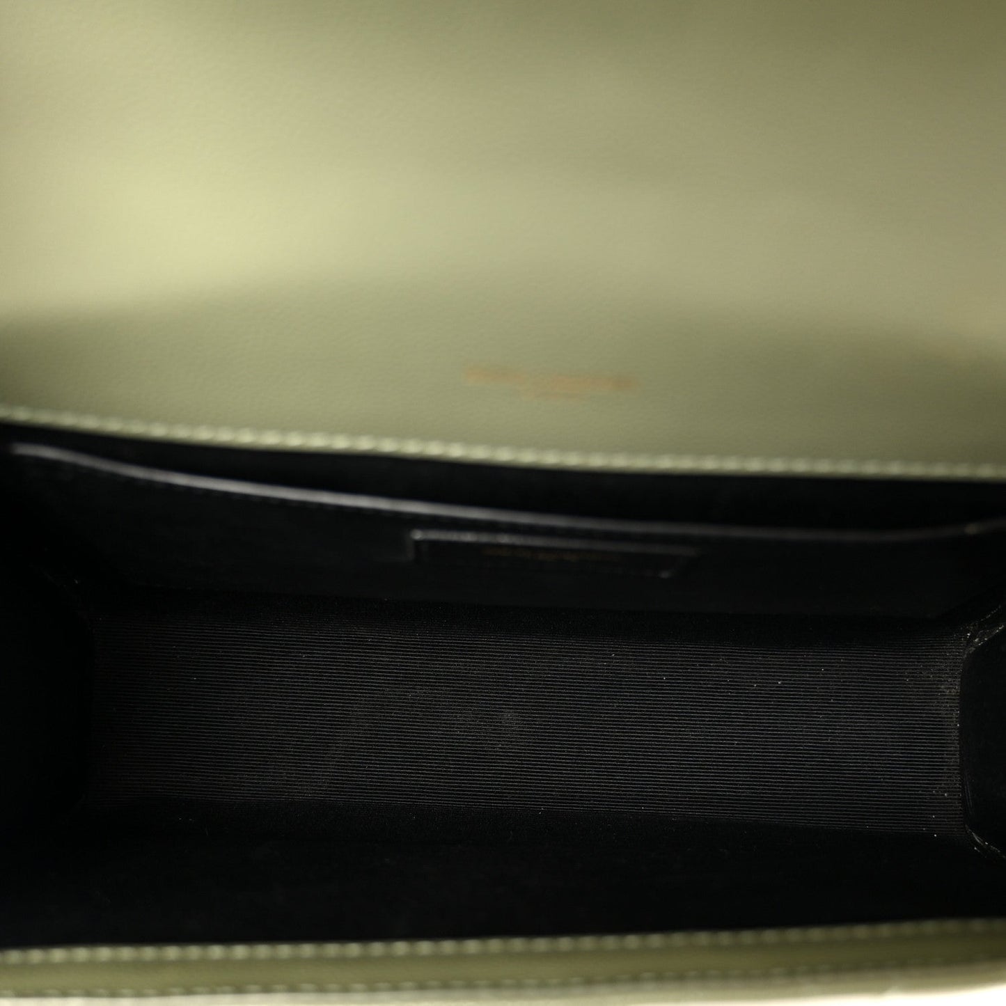 Dark leather satchel interior lining with zipper edge detail
