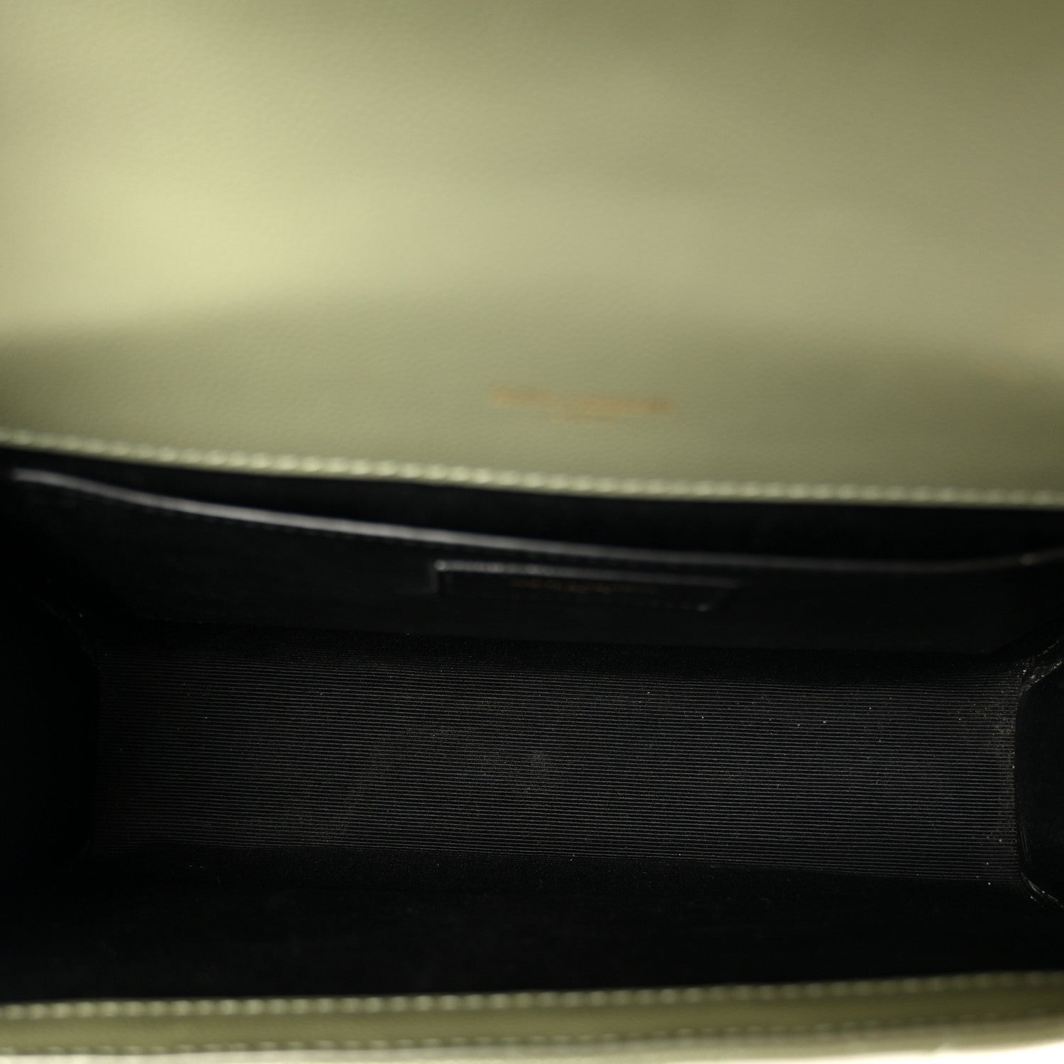 Dark leather satchel interior lining with zipper edge detail