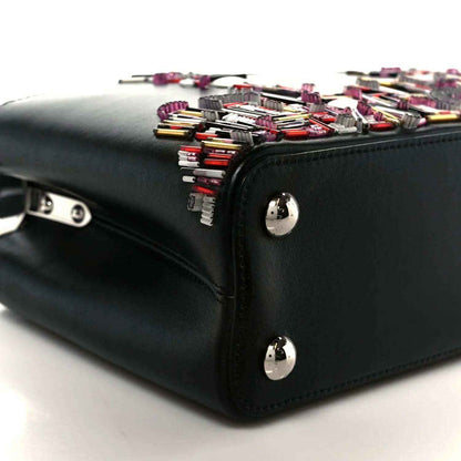 Capucines BB black bag side with silver feet and colorful beaded skyline top