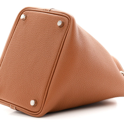 Brown leather bucket tote bag bottom corner with metal snaps and stitched edges