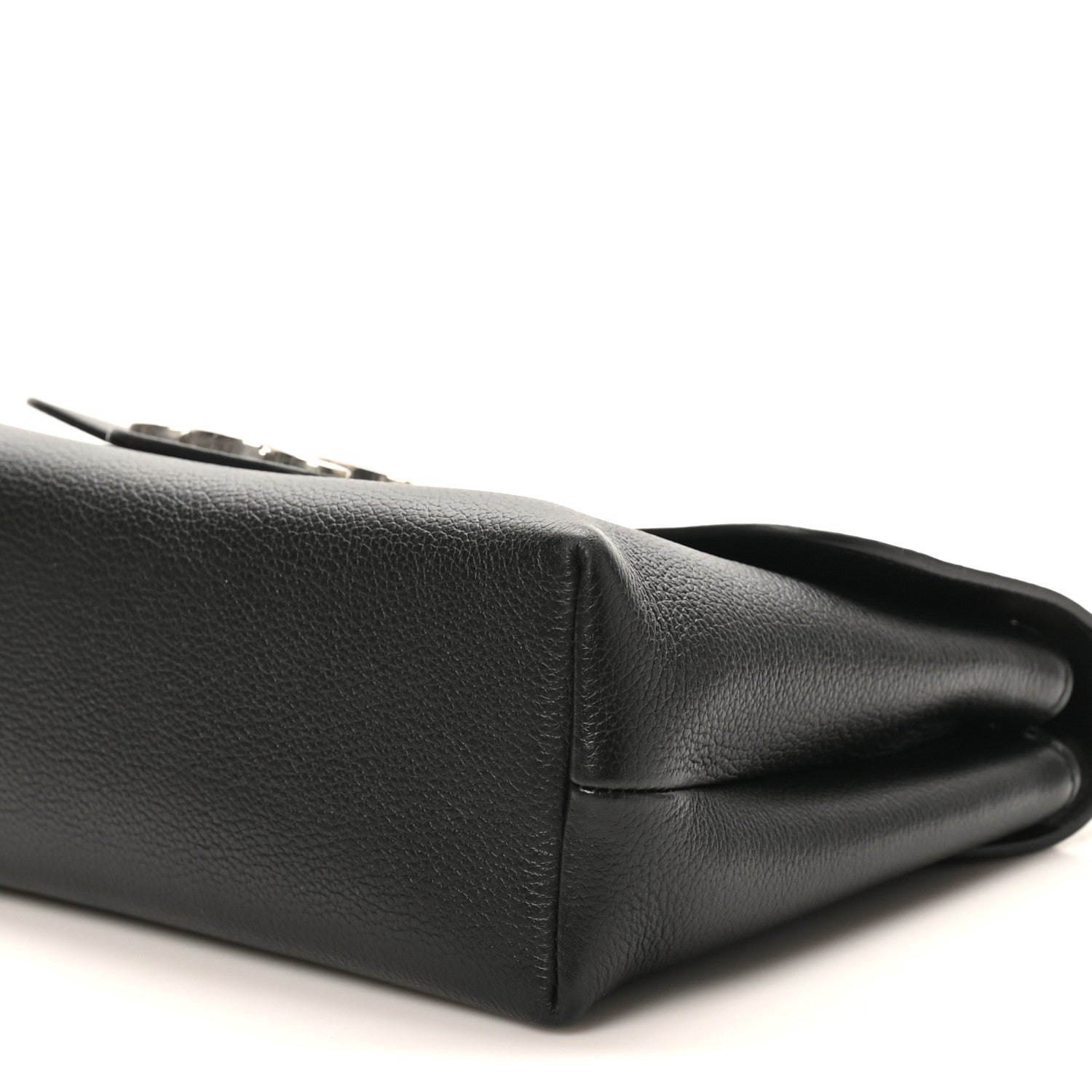 Black calfskin bag side close-up with stitched panel and folded edge