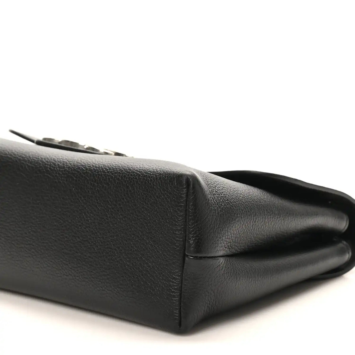 Black calfskin bag side close-up with stitched panel and folded edge