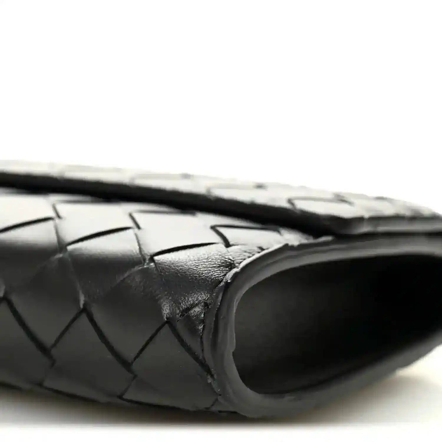 Black woven leather clutch with rounded end and top handle