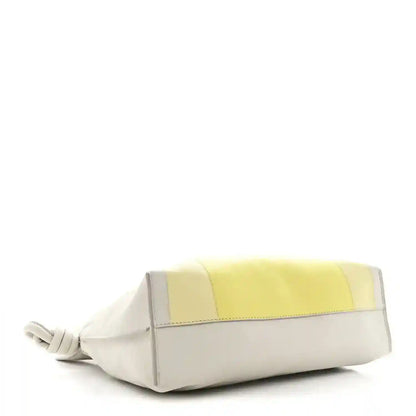 Knot clutch with pale grey leather and light citrine panel on front band