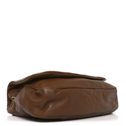 Light brown quilted lambskin shoulder bag shown from the side/back, chain strap
