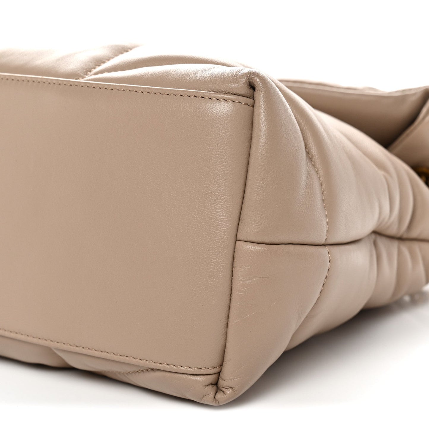 Dark beige quilted satchel side panel detail with stitched seams