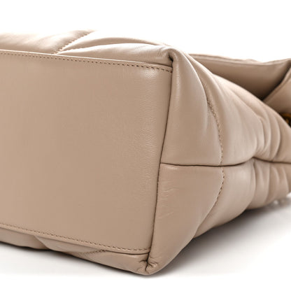 Dark beige quilted satchel side panel detail with stitched seams