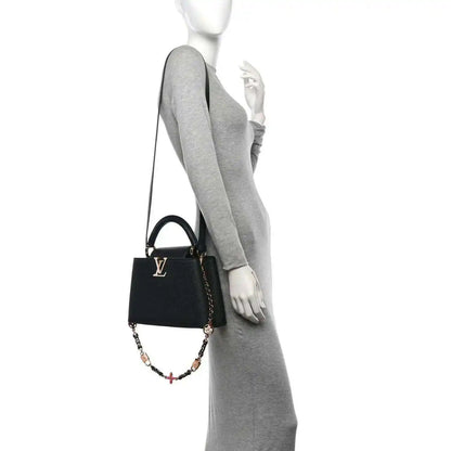 Black leather mini handbag with chain crossbody strap on model