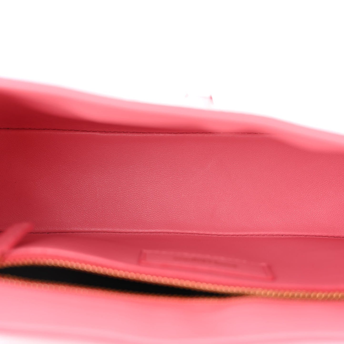 Pink alligator-textured hobo bag interior opening with gold zipper trim