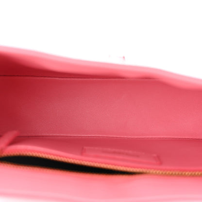 Pink alligator-textured hobo bag interior opening with gold zipper trim