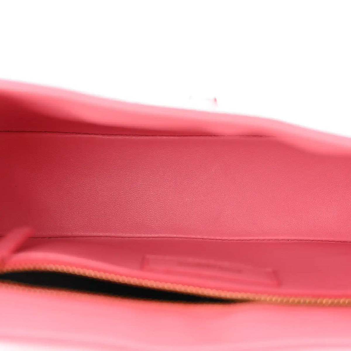 Pink alligator-textured hobo bag interior opening with gold zipper trim