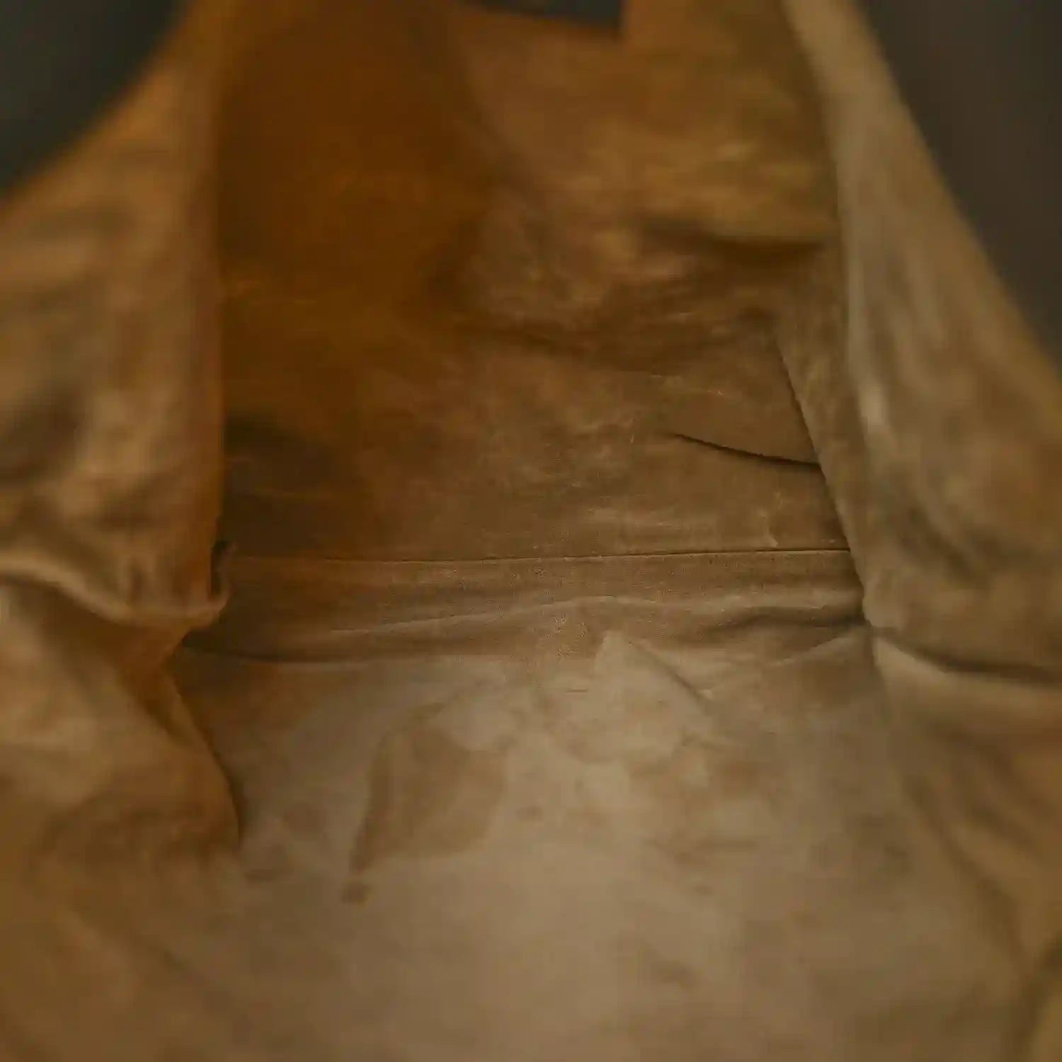 Tan suede-like interior lining with visible texture and smooth seams.