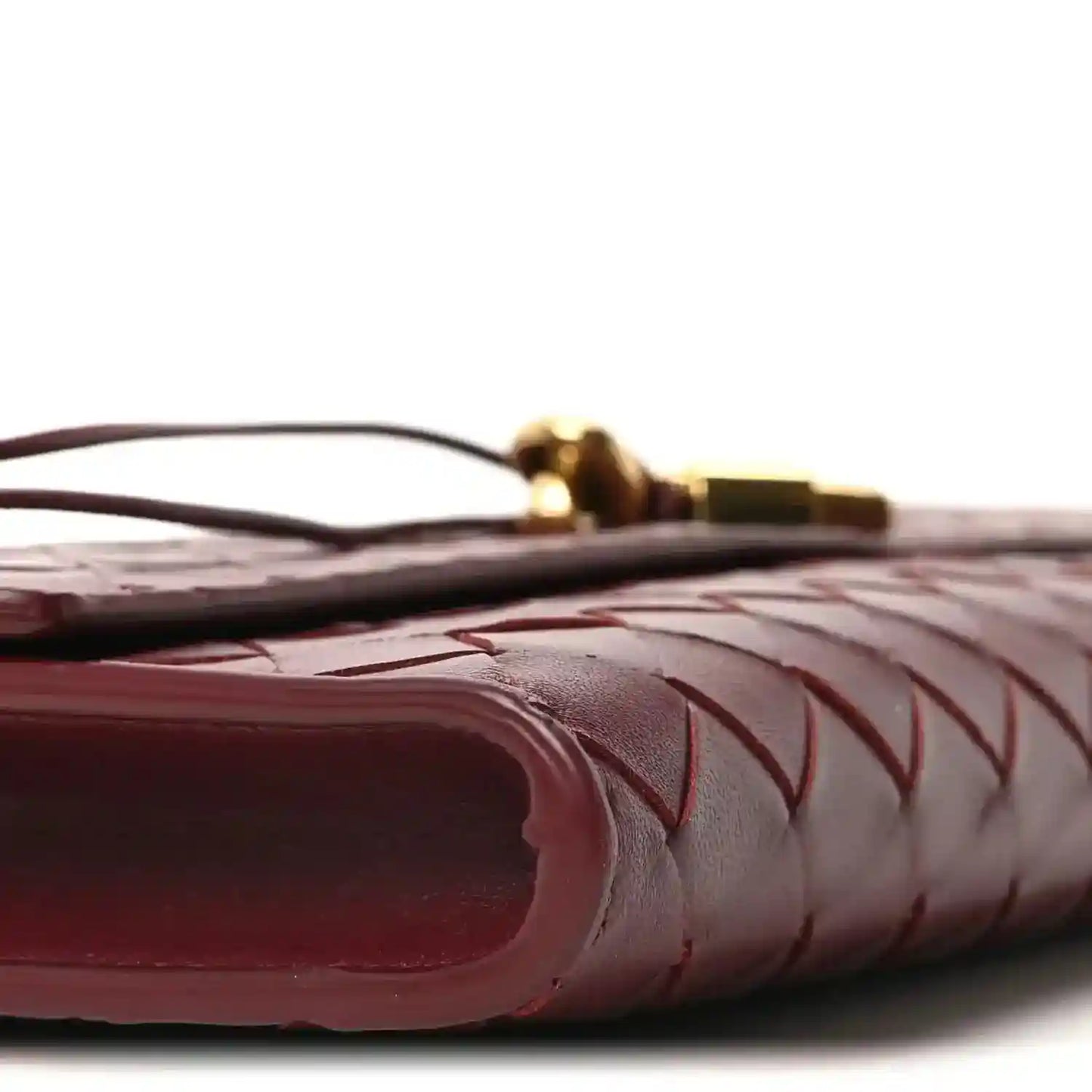 Bottega Veneta intrecciato leather clutch corner detail in barolo, close-up