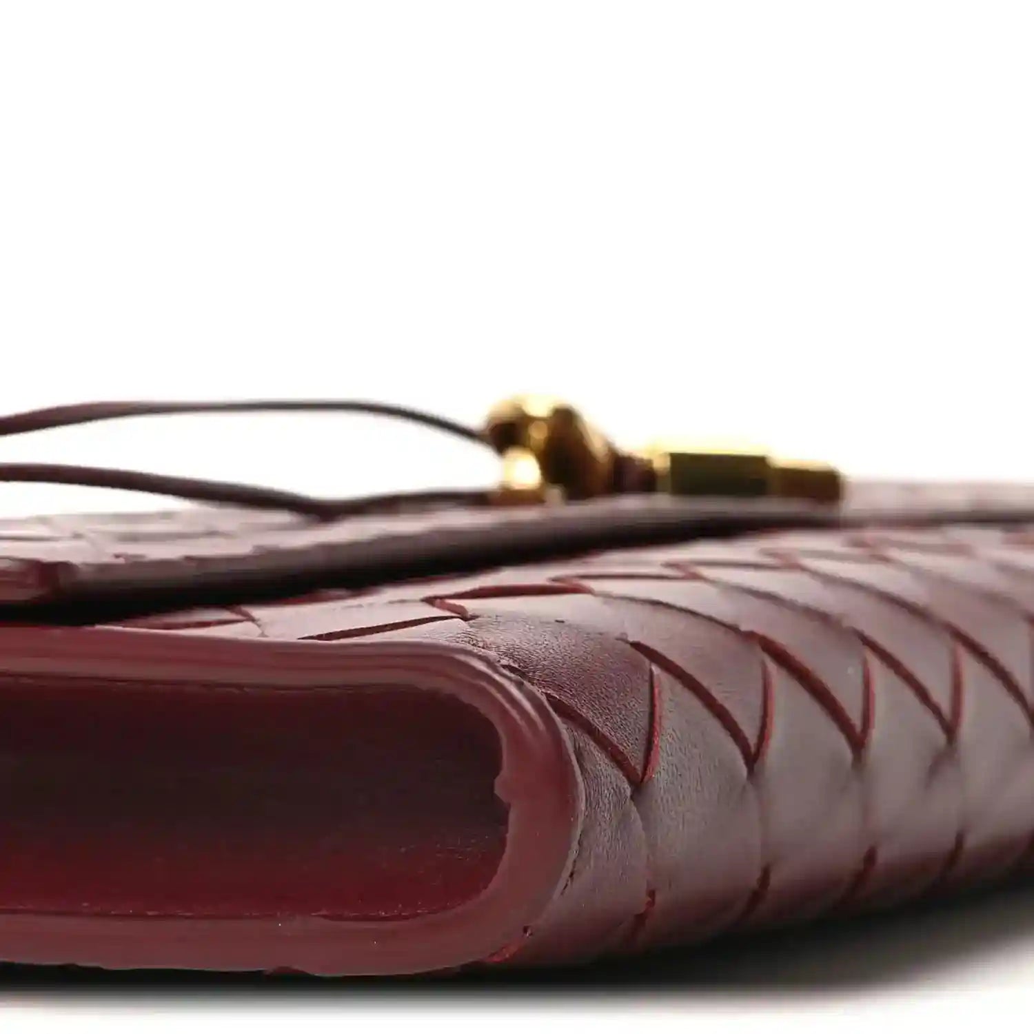 Bottega Veneta intrecciato leather clutch corner detail in barolo, close-up