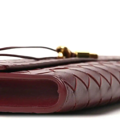 Bottega Veneta intrecciato leather clutch corner detail in barolo, close-up