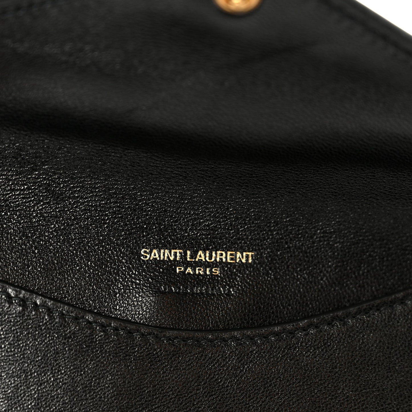 Black leather shoulder bag interior with 'SAINT LAURENT PARIS' emboss