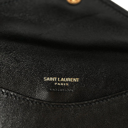 Black leather shoulder bag interior with 'SAINT LAURENT PARIS' emboss