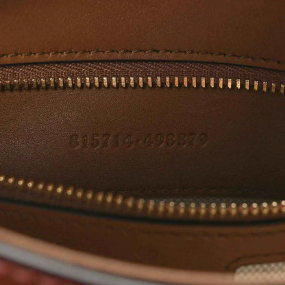 Brown leather exterior with gold zipper and embossed serial code
