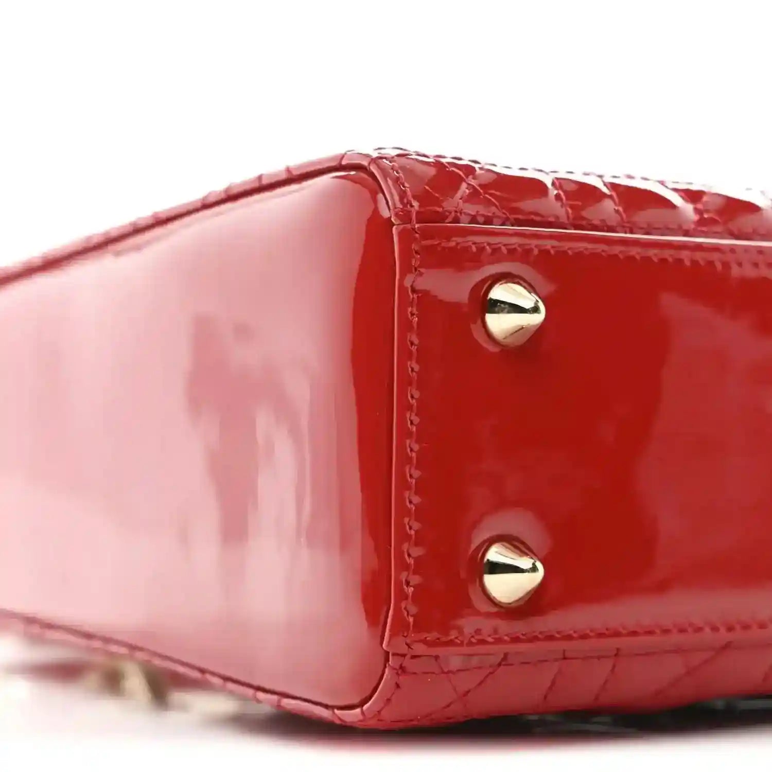 Christian Dior small red patent quilted handbag, close-up of top edge and gold stud