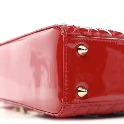 Christian Dior small red patent quilted handbag, close-up of top edge and gold stud