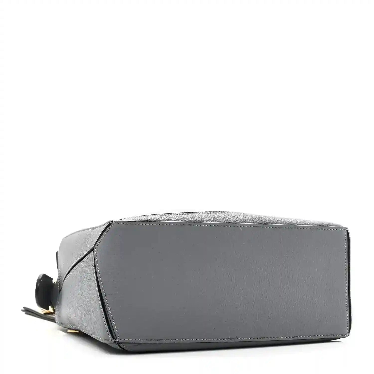 Small puzzle bag in dark gray leather with structured rectangular base and side panel seams