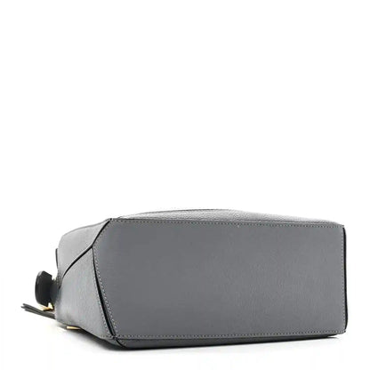 Small puzzle bag in dark gray leather with structured rectangular base and side panel seams