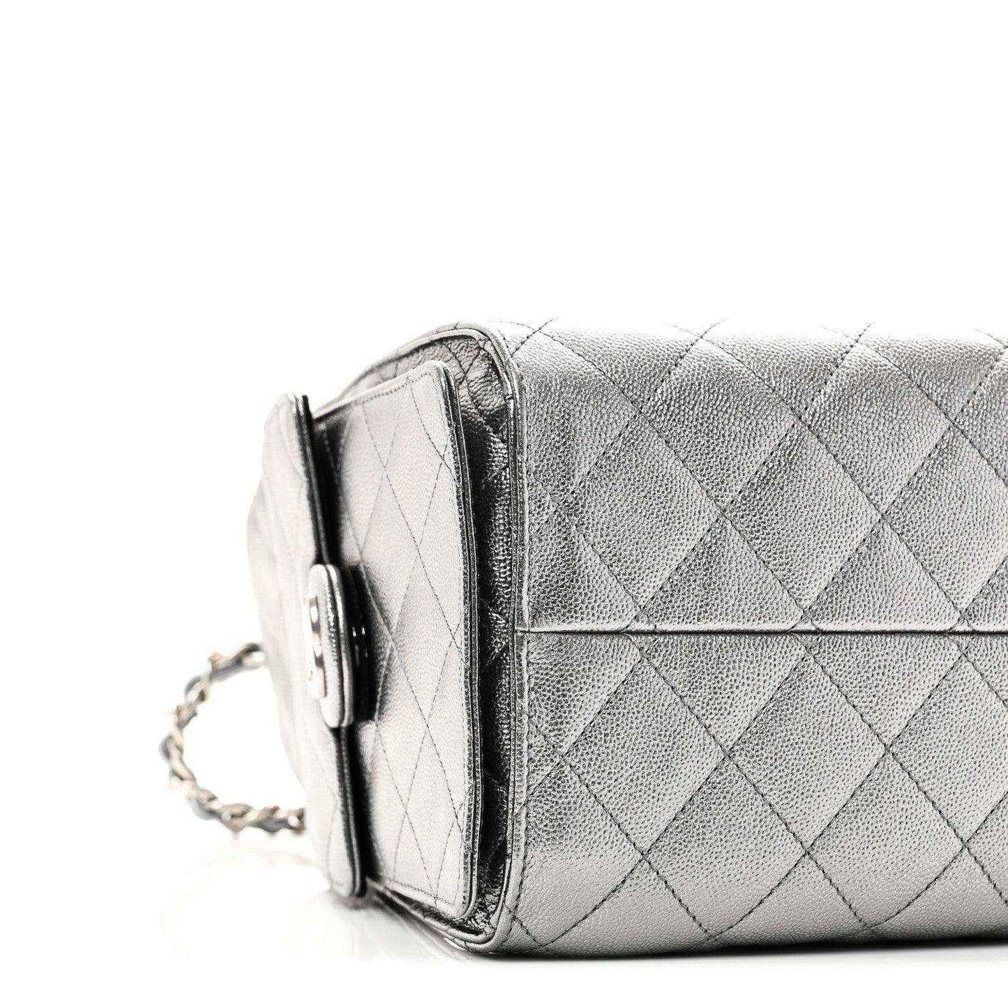 Chanel metallic caviar quilted handbag side view with flap pocket and chain strap