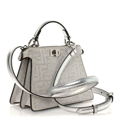Silver crystal leather satchel with curved strap, top handle, and flap clasp