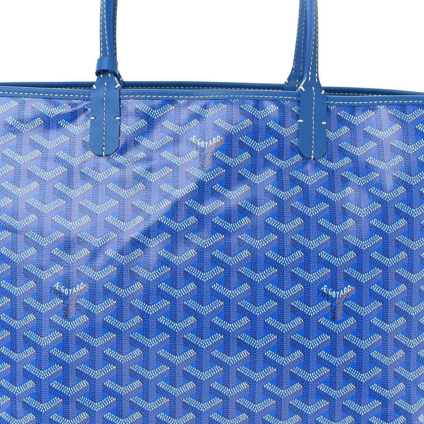 Sky blue tote bag with Goyardine monogram pattern and central vertical strap