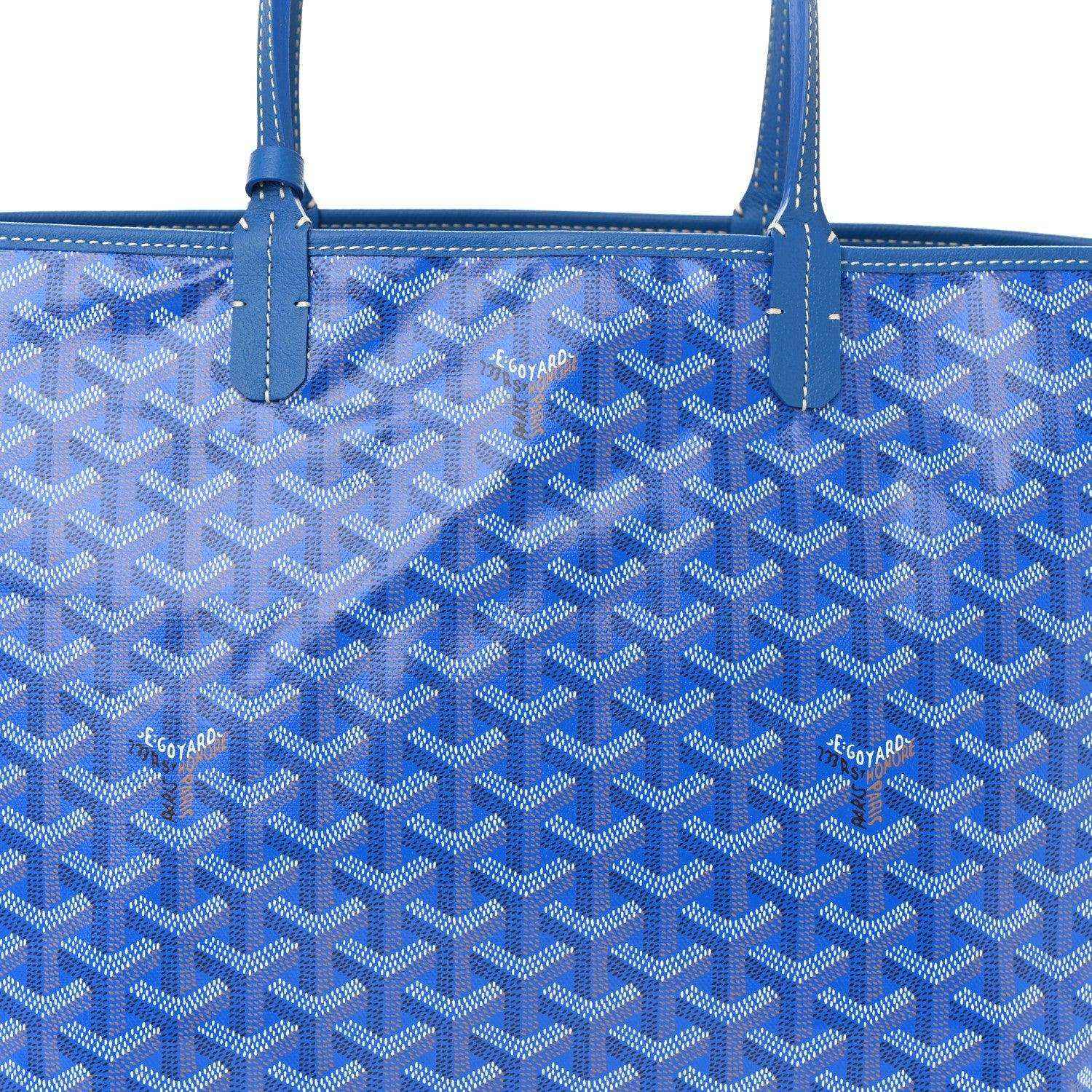 Sky blue tote bag with Goyardine monogram pattern and central vertical strap