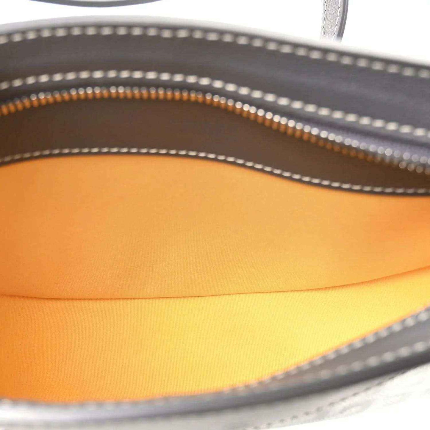 Shoulder bag interior lining in orange with visible zipper track