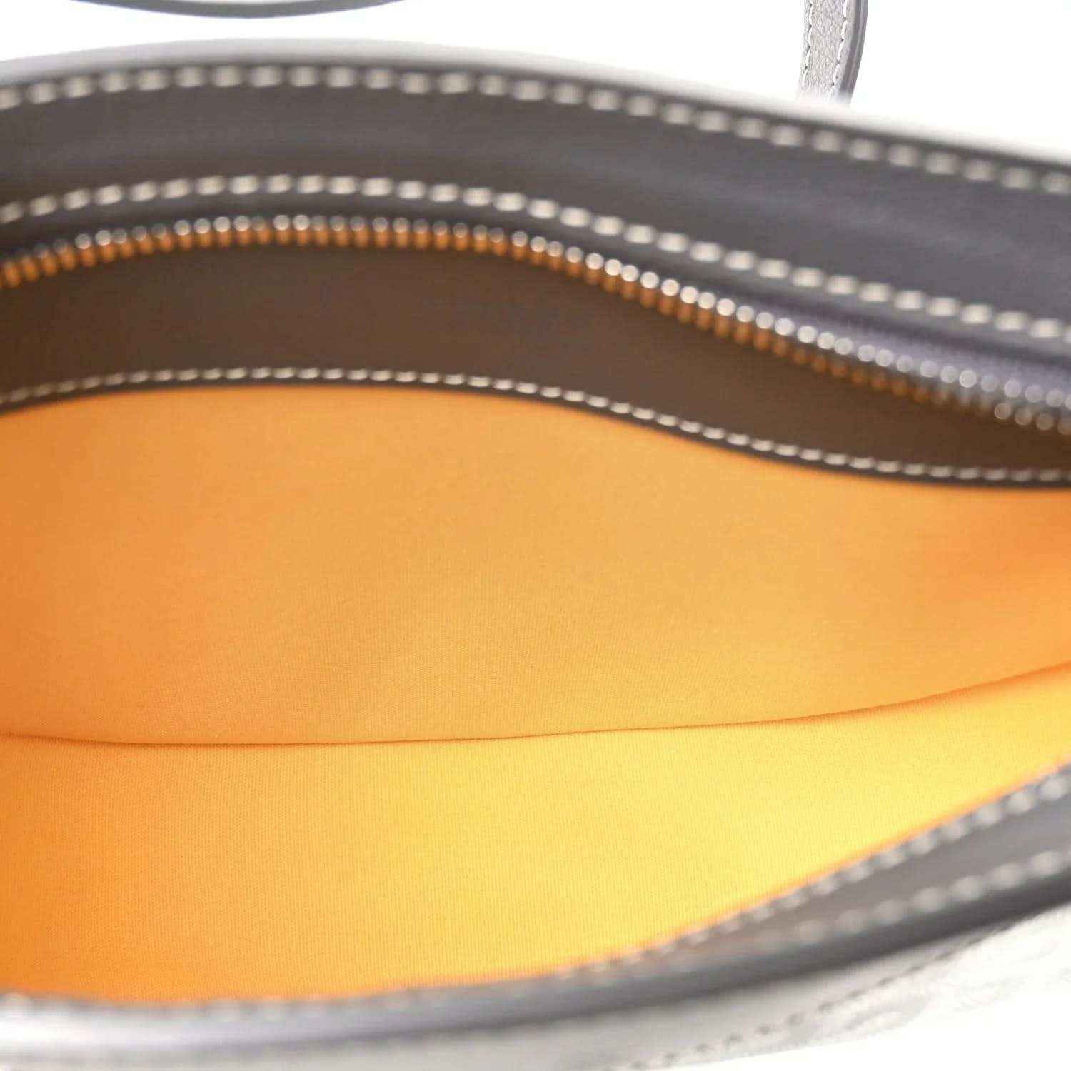 Shoulder bag interior lining in orange with visible zipper track