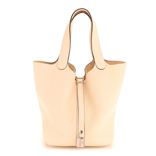 Light beige leather bucket bag with top handles and front lock closure