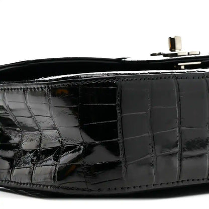Black glossy alligator side panel with flap seam and interior opening.