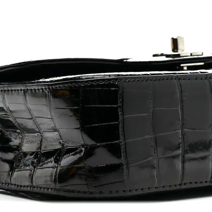 Black glossy alligator side panel with flap seam and interior opening.