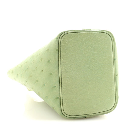 Green mini handbag end panel with rounded-rectangle trim and subtle grain texture