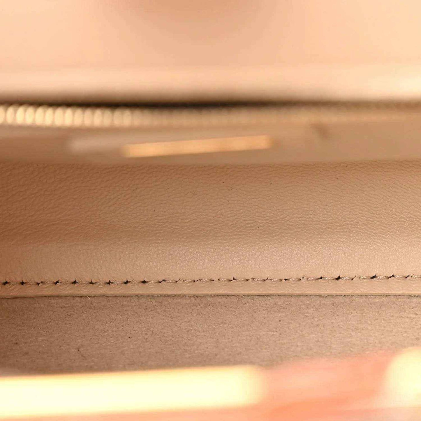 Mini Peekaboo satchel interior close-up with stitched detailing along edge