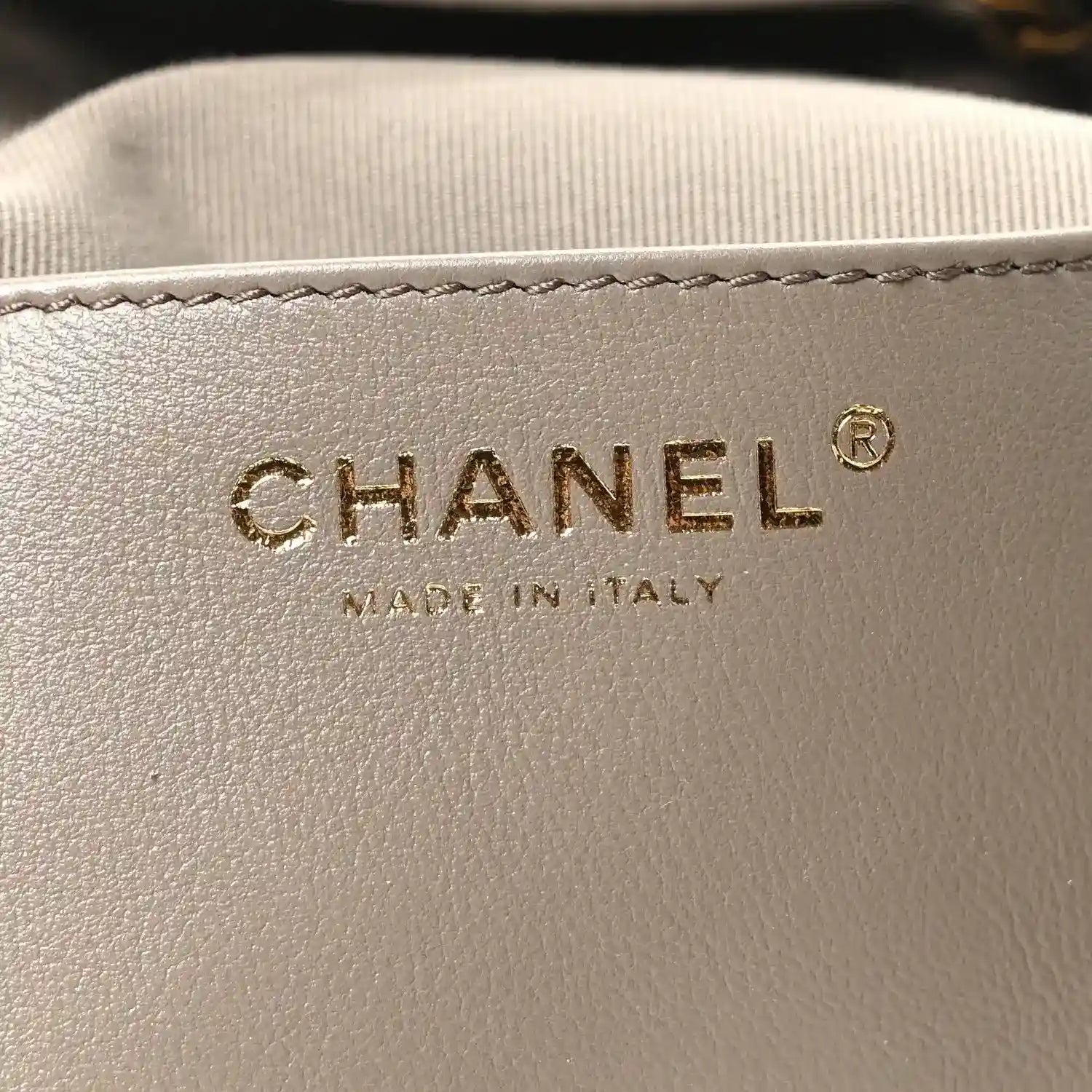 Chanel suede bag label with "CHANEL" and "MADE IN ITALY" text