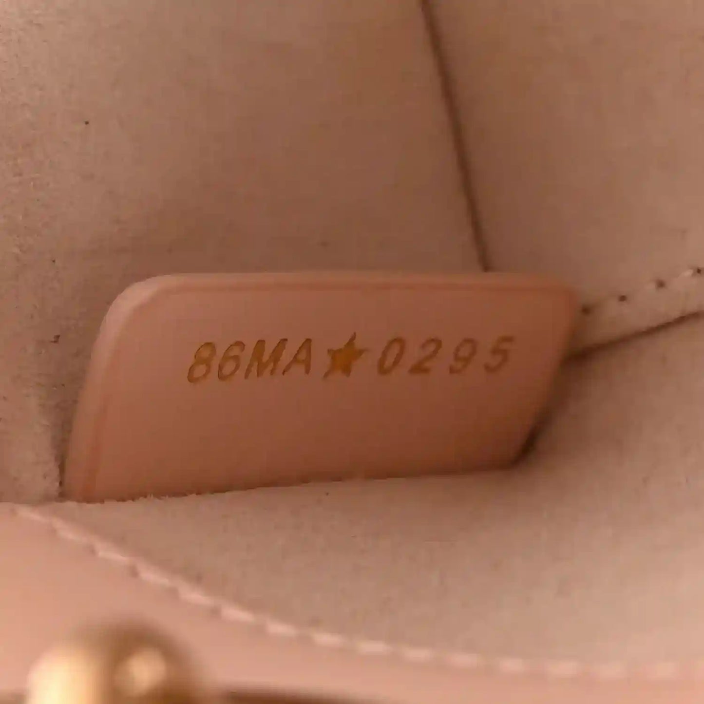 Leather interior stamped code “86MA☆0295” visible inside mini handbag